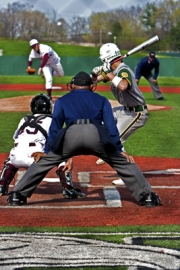 Ann Arbor Gabriel Richard batter rocks back to slap a hanging curve by Ann Arbor Pioneer Pitcher.